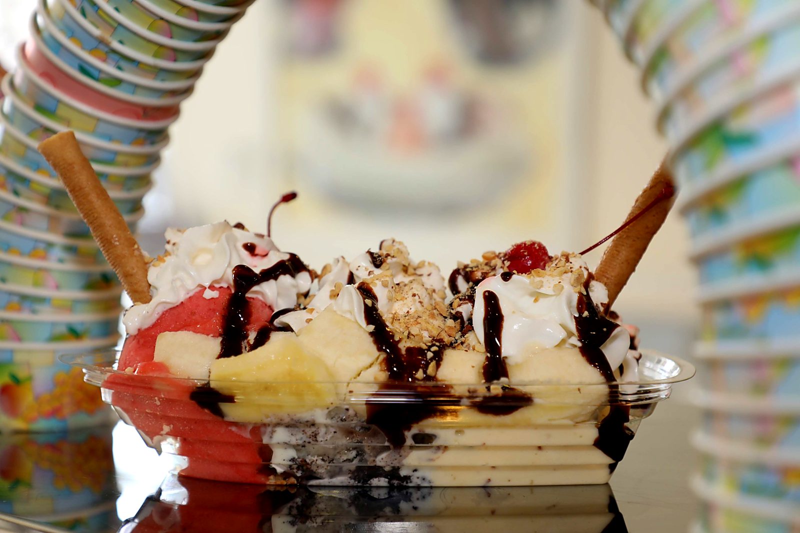 Banana split with gelato, whipped cream, chocolate sauce, nuts and cherries